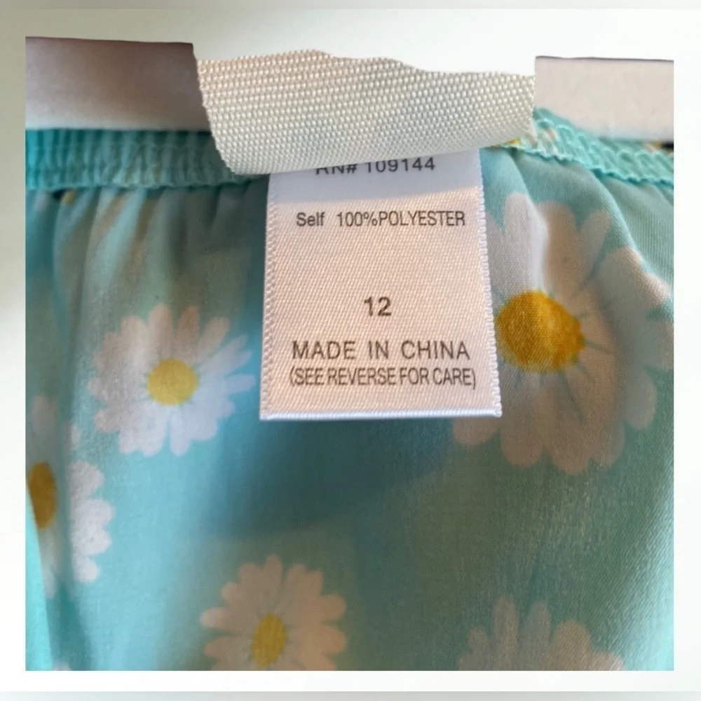 Lily Bleu Short romper in light blue aqua with white flowers and tie front.